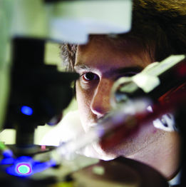 Photograph of researcher using  electrophysiology equipment
